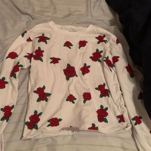 White shirt with roses .